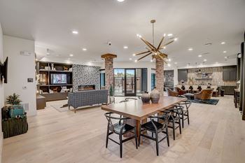 A modern living room with a wooden table and chairs.